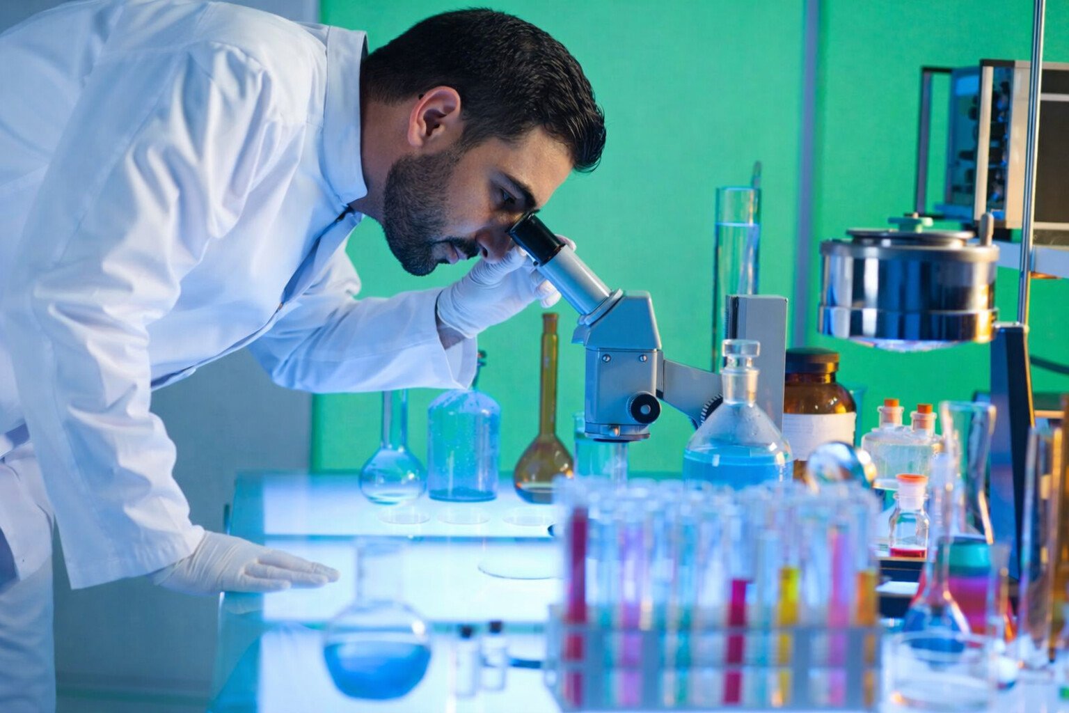 Arab doctor looking though microscope